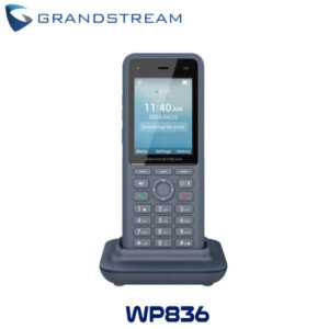 Front view of the Grandstream WP836 cordless phone displaying time and date on the screen while resting in its charging dock.